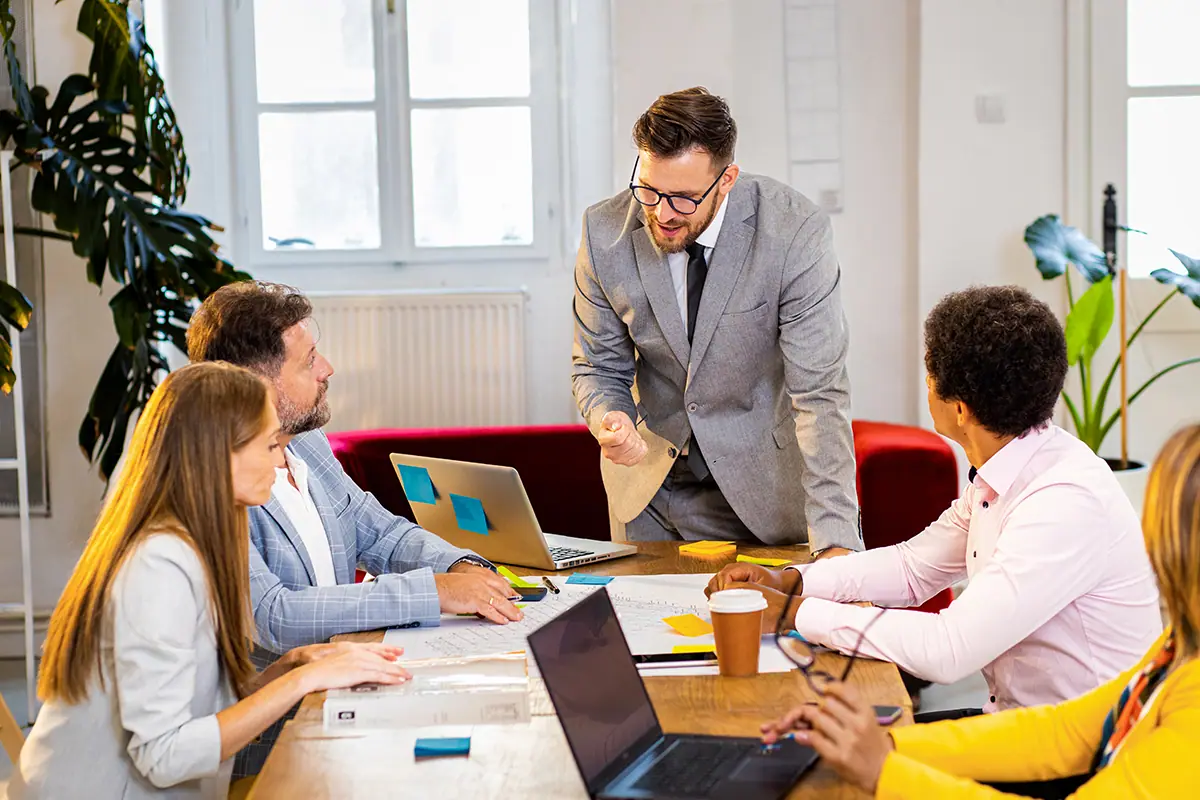 A coach working through a plan with a group of business owners